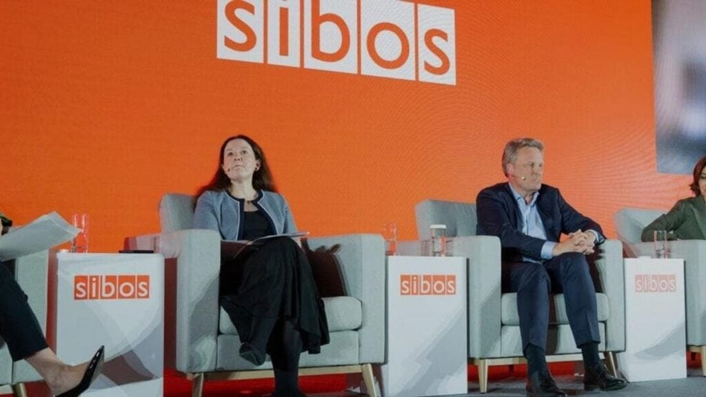 Speakers on stage during a panel discussion at the Sibos conference
