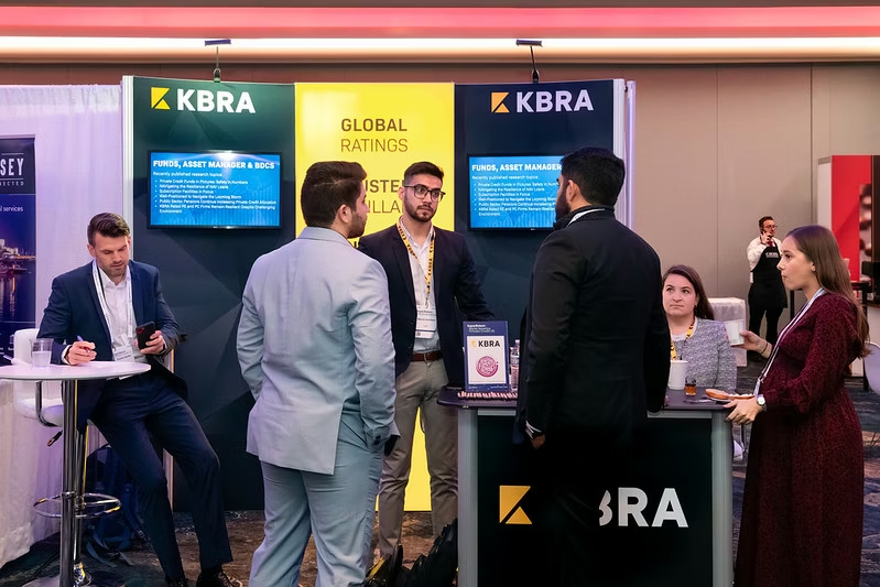 Attendees at an exhibitor's booth at the Super Retun North America