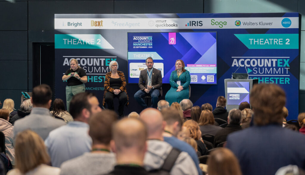 Panelists seated on stage in front of an audience at Accountex Summit Manchester.